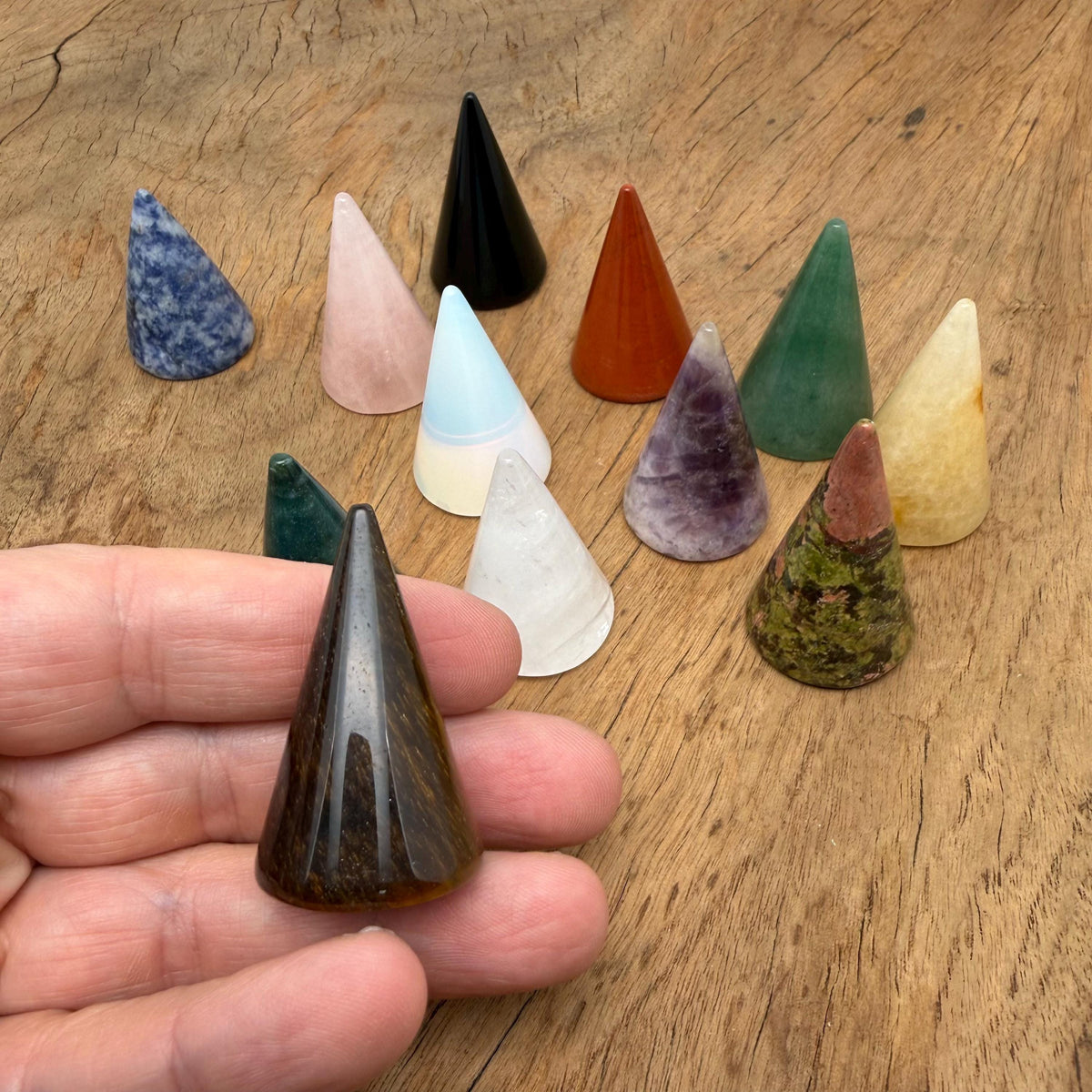 Carved gemstone cone ring holder by GemstoneGO, jewelry display stand for organizing and showcasing rings.