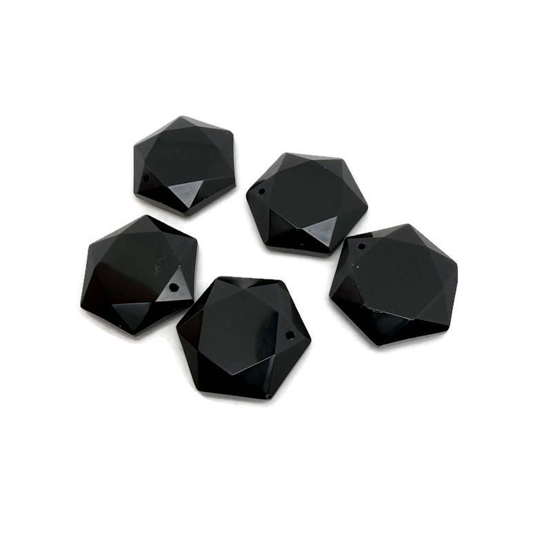 Faceted obsidian hexagon crystal pendant necklace with a polished stone bead, showcasing a sleek, dark gemstone design.