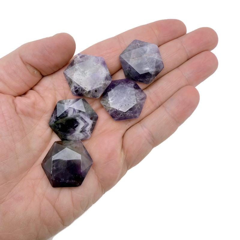 Faceted amethyst hexagon crystal pendant necklace with gemstone bead, showcasing a purple gemstone on a silver chain.