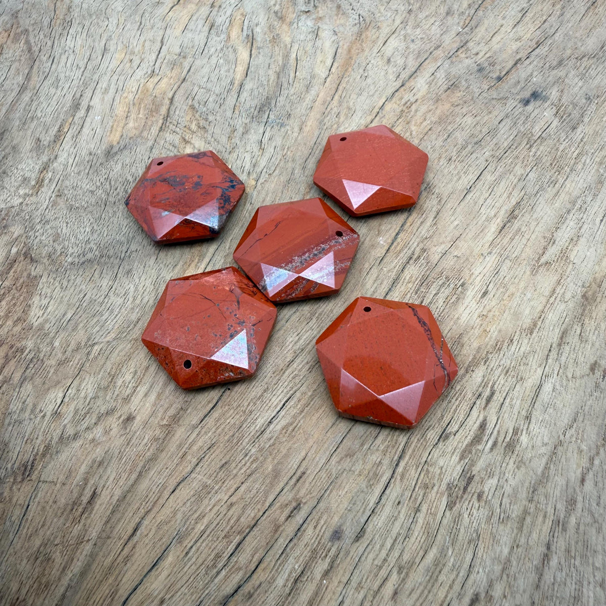 Red Jasper hexagon crystal pendant necklace with faceted stone bead from GemstoneGO, showcasing a polished, vibrant red gemstone pendant.