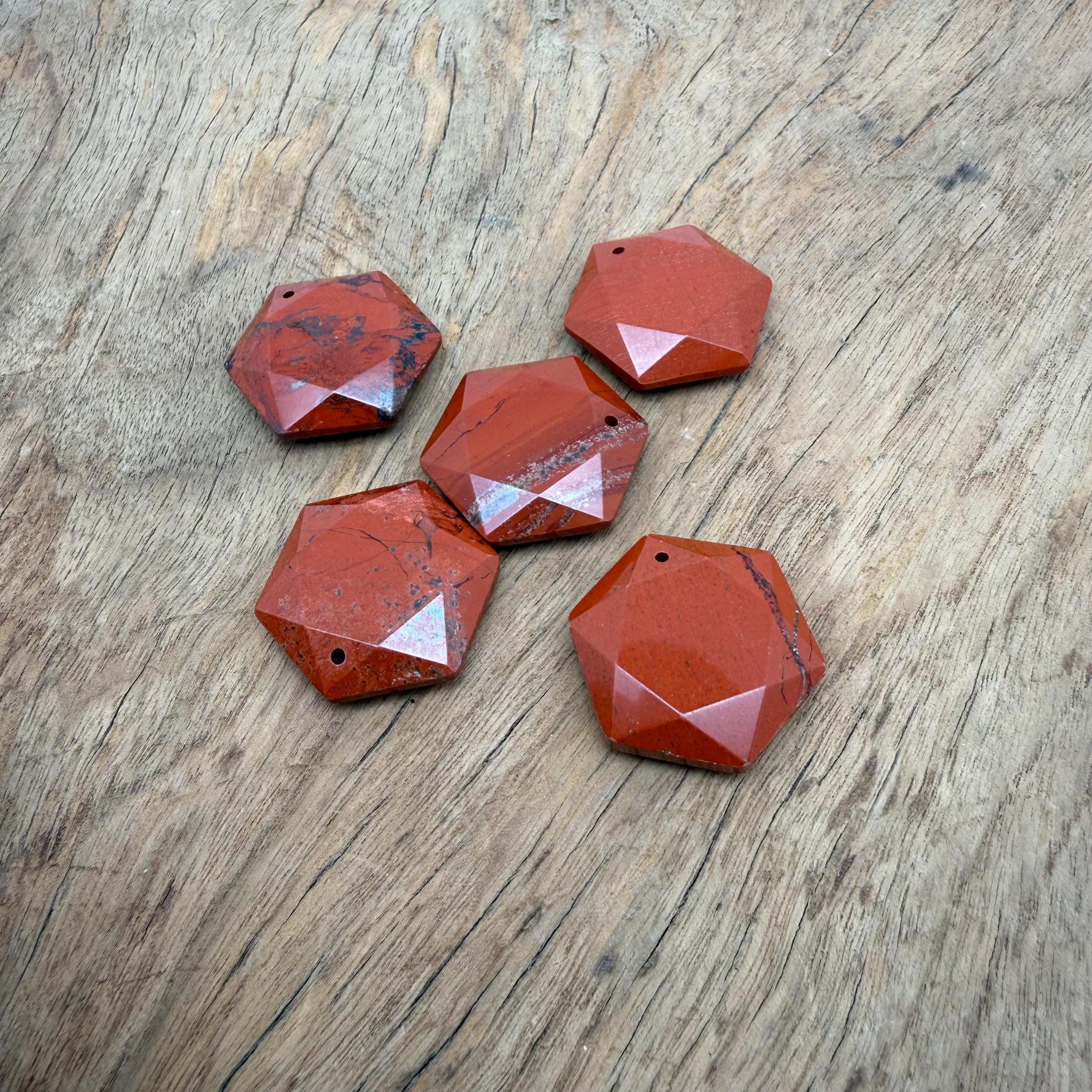 Red Jasper hexagon crystal pendant necklace with faceted stone bead from GemstoneGO, showcasing a polished, vibrant red gemstone pendant.