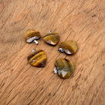 Tiger Eye faceted heart crystal pendant from GemstoneGO, featuring natural gemstone charm with a polished, faceted heart shape.