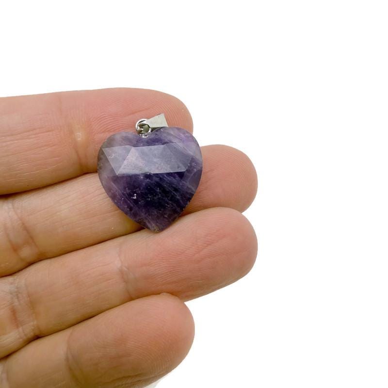 Faceted amethyst crystal heart pendant from GemstoneGO, showcasing a natural purple gemstone charm with detailed facets.