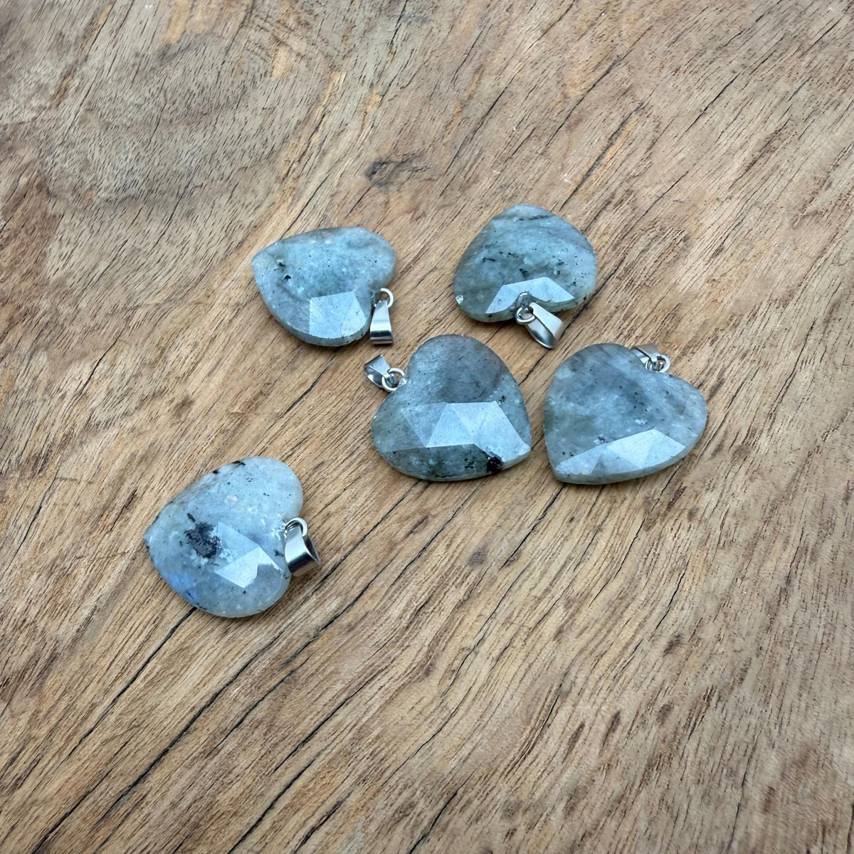 Faceted Labradorite heart crystal pendant by GemstoneGO showcasing a natural, shimmering gemstone charm with intricate faceting.