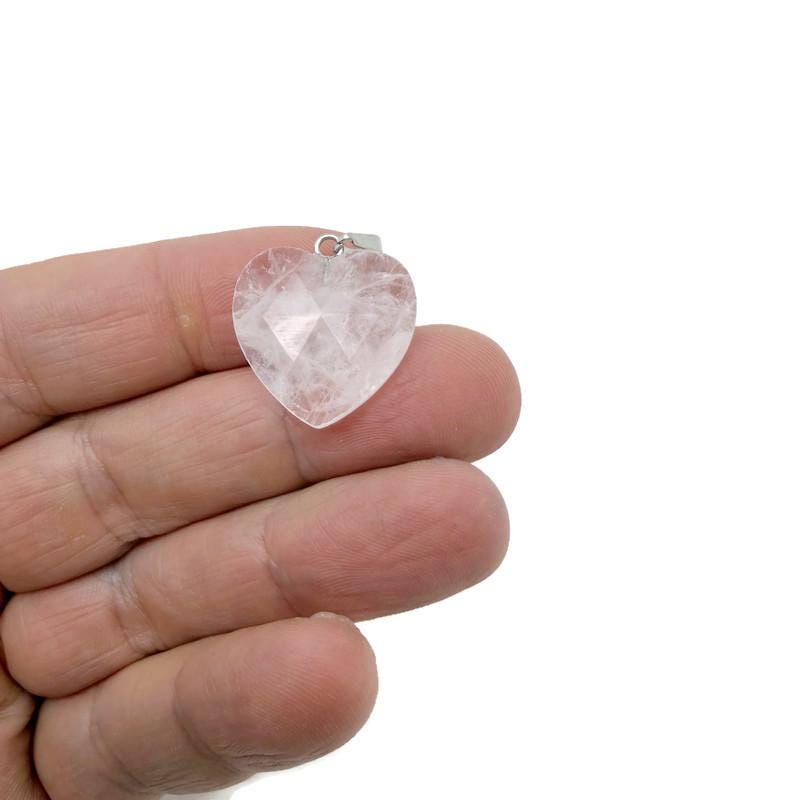 Faceted clear quartz heart crystal pendant from GemstoneGO, showcasing a natural, polished gemstone charm with a silver bail.