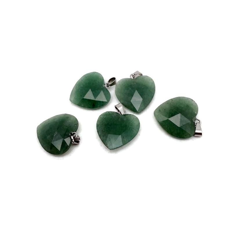 A faceted aventurine heart crystal pendant with natural gemstone charm, showcasing a polished green gemstone with intricate facets.