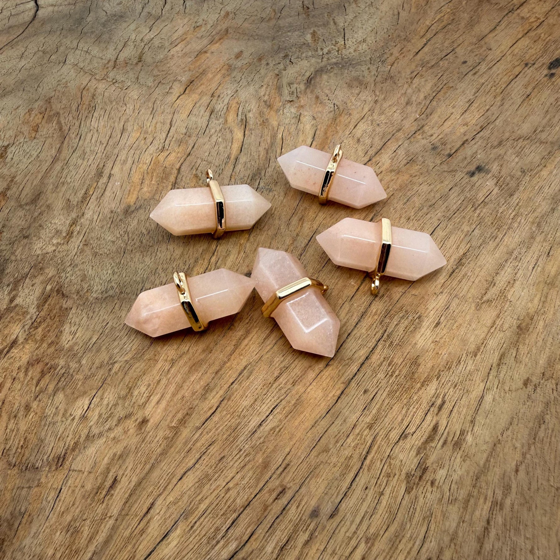 Orange aventurine double terminated crystal pendant with natural gemstone points, showcasing vibrant orange color and polished surface.