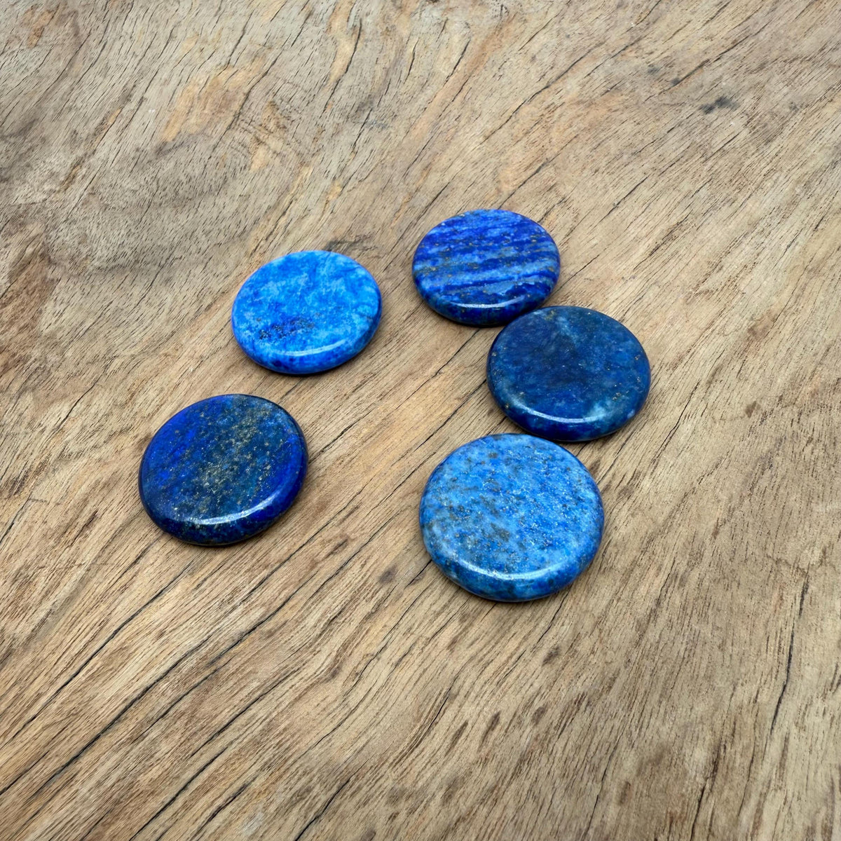 Round lapis lazuli flat gemstone slab, 25mm, vibrant deep blue with gold pyrite inclusions, from GemstoneGO.