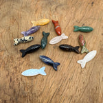 Handmade fish-shaped gemstone pendant from GemstoneGO, featuring colorful stones, used as a lucky fishing charm or gift.