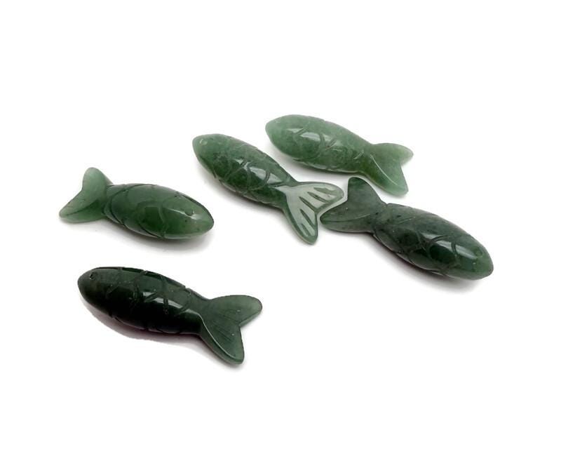 A green aventurine fish-shaped gemstone pendant, featuring a polished surface, designed as a lucky fishing charm gift.