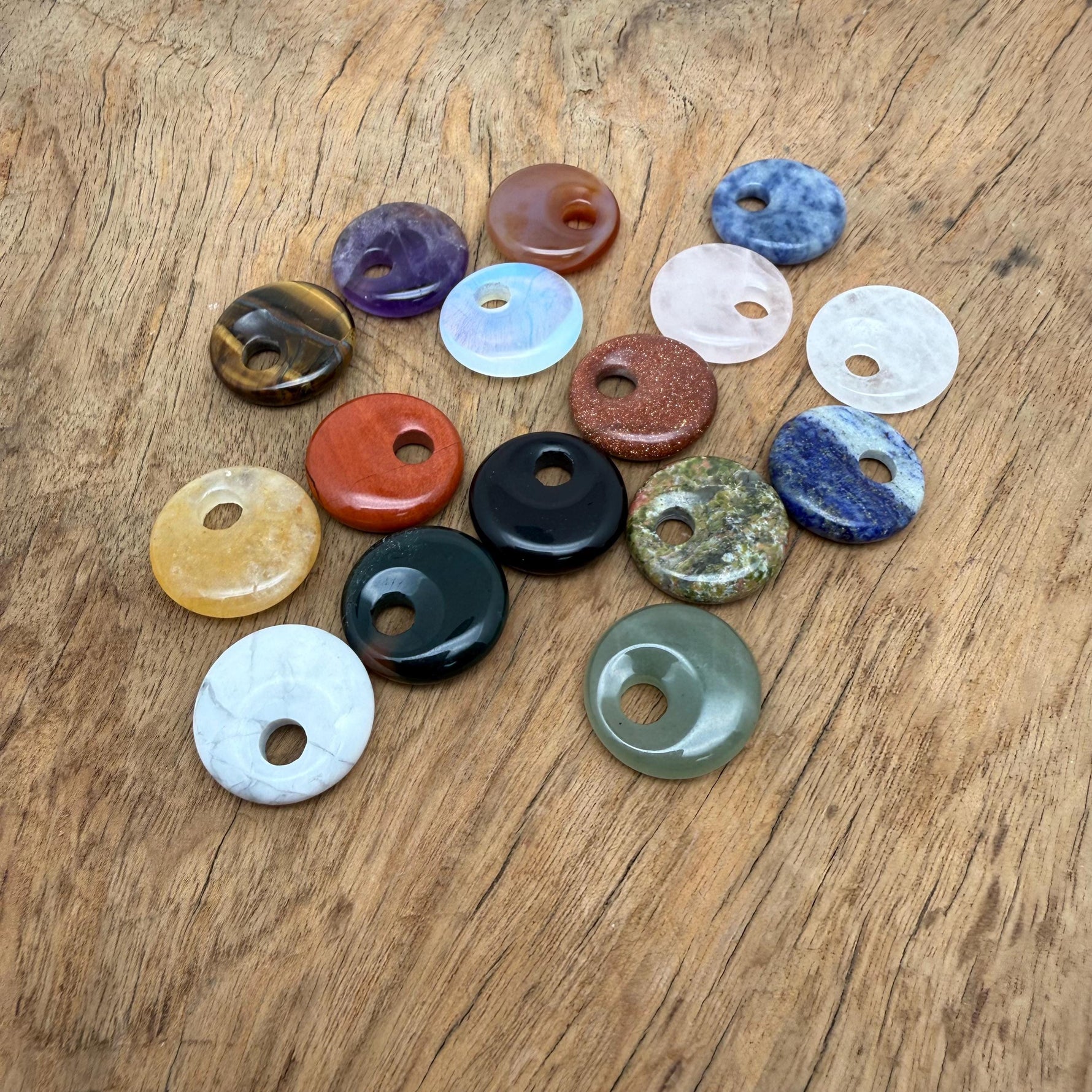 Natural crystal donut charm from GemstoneGO, 20mm Pi Stone design, featuring a colorful mixed gemstone pattern.