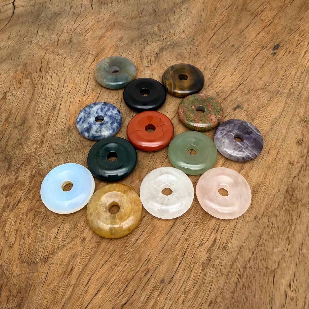 Colorful gemstone crystal donut with a Pi symbol, 30mm size, from GemstoneGO's mixed collection, perfect as a gift or decorative item.
