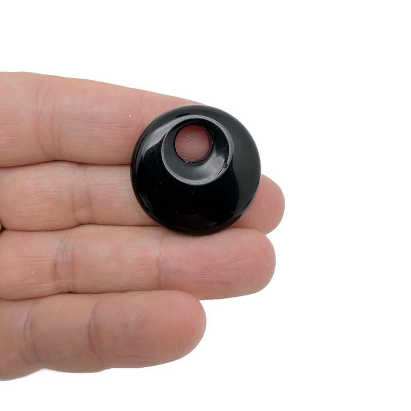 Polished crystal donut pendant from GemstoneGO, 30mm Pi Stone healing crystal component with a smooth, shiny surface and natural color variation.