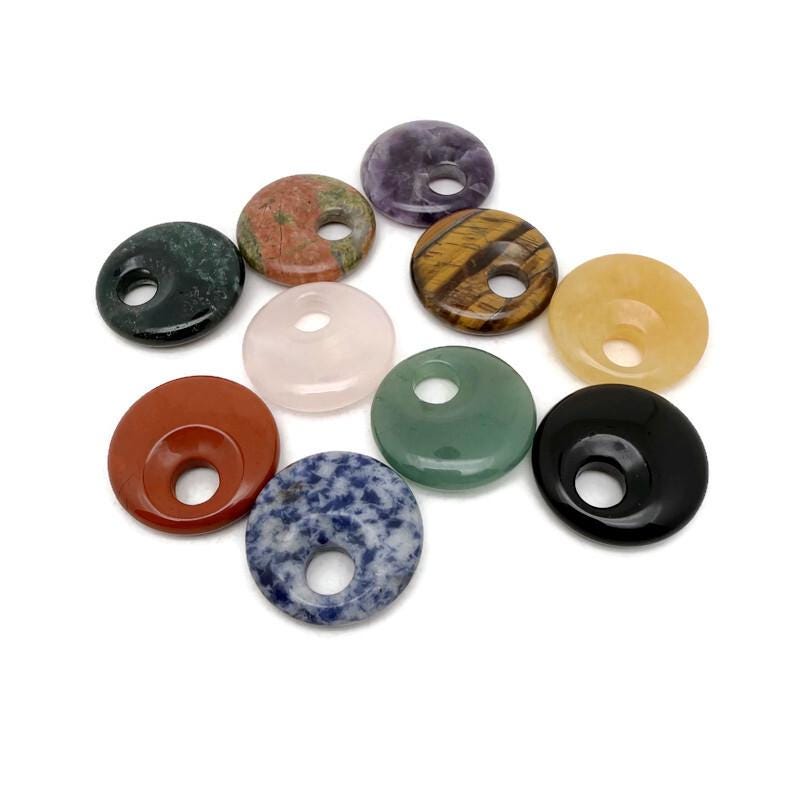 Polished 30mm Pi Stone healing crystal donut from GemstoneGO, featuring colorful mixed gemstones and a smooth, polished surface.