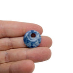 Blue sodalite crystal donut pendant, 20mm Pi Stone from GemstoneGO, polished gemstone with natural blue and white patterns.