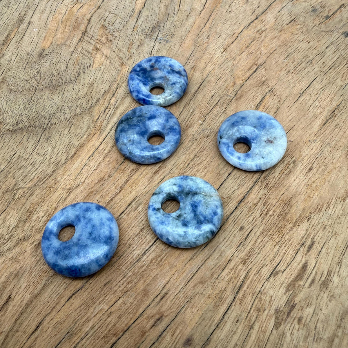 Sodalite crystal donut pendant with a 20mm Pi stone shape, featuring deep blue and white mineral patterns, from GemstoneGO.