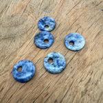 Sodalite crystal donut pendant with a 20mm Pi stone shape, featuring deep blue and white mineral patterns, from GemstoneGO.