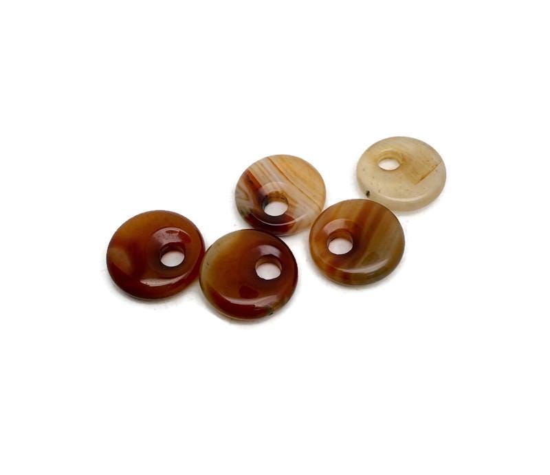 Carnelian crystal donut pendant from GemstoneGO, 20mm Pi Stone with rich orange-red color and smooth polished surface.