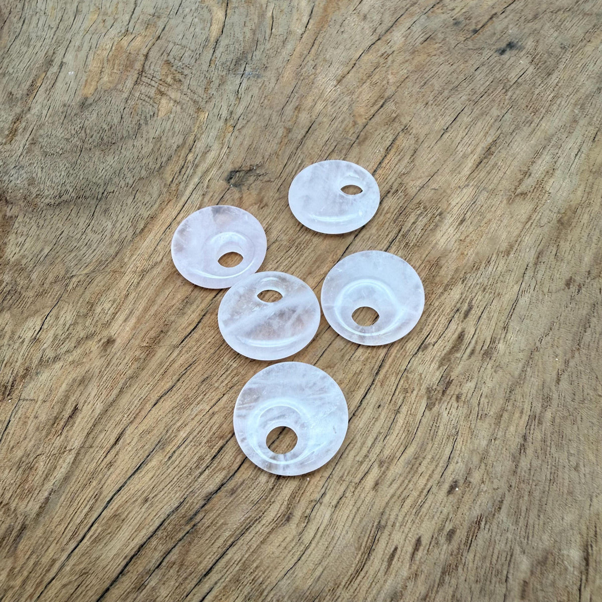 Pink rose quartz crystal donut pendant, 20mm Pi stone with smooth polished surface, from GemstoneGO.