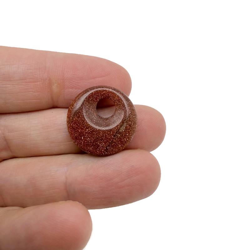 Golden Goldstone crystal donut pendant, 20mm Pi stone from GemstoneGO, showcasing a polished, sparkling gemstone with intricate details.