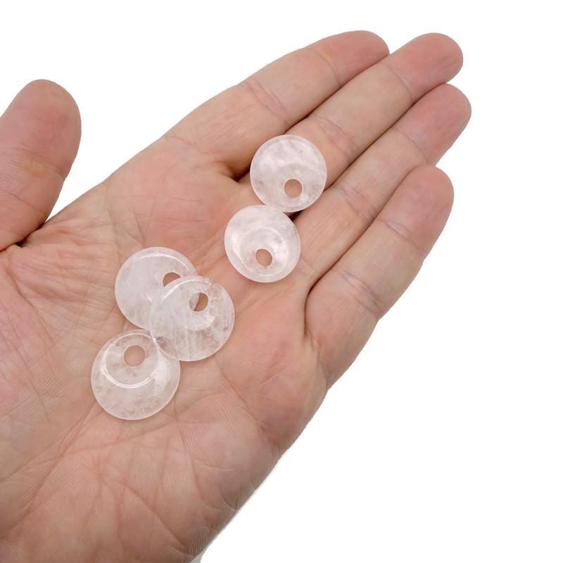 Clear Quartz crystal donut pendant from GemstoneGO, 20mm Pi Stone with a polished, transparent gemstone shape.