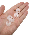 Clear Quartz crystal donut pendant from GemstoneGO, 20mm Pi Stone with a polished, transparent gemstone shape.
