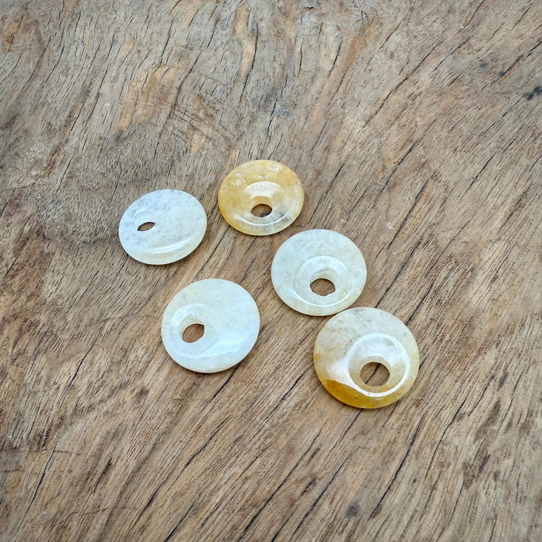 Yellow jade crystal donut pendant, 20mm Pi stone with a polished surface, from GemstoneGO.