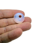 Opalite crystal donut pendant, 20mm Pi stone from GemstoneGO, showing a smooth, polished translucent gemstone with swirling patterns.