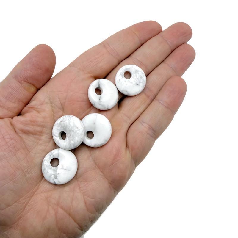 Light gray Howlite crystal donut with natural veining, 20mm Pi stone from GemstoneGO, showcasing smooth, polished surface and unique pattern.