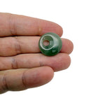A 20mm aventurine crystal donut pendant with a polished green gemstone, showcasing its smooth, rounded shape and natural stone pattern.