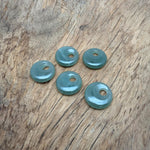 A 20mm aventurine crystal donut pendant with natural green hues and smooth polished surface, showcasing gemstone beauty.