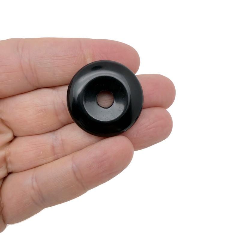 30mm obsidian crystal donut with Pi stone design from GemstoneGO, showcasing a smooth, polished black gemstone with intricate details.