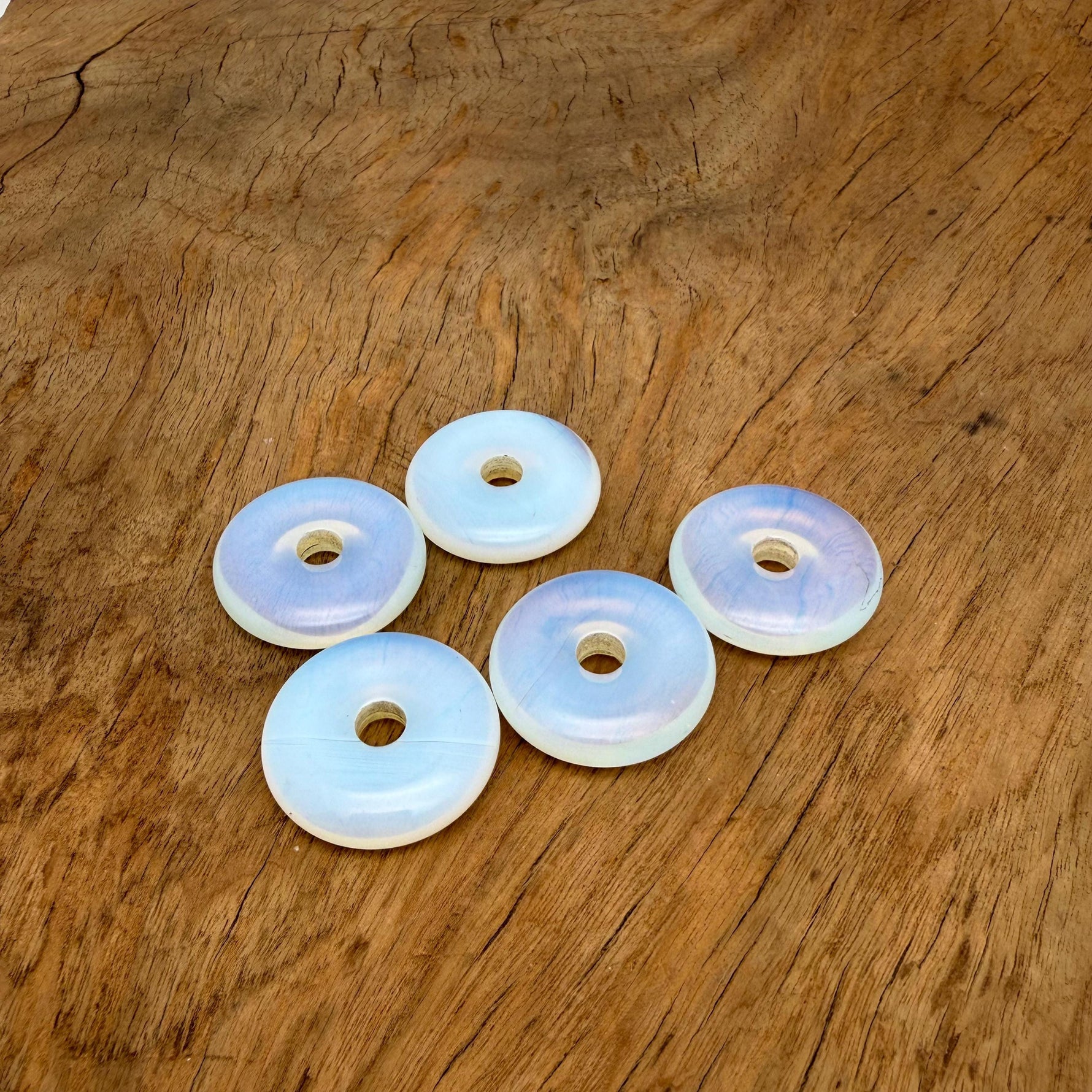Opalite crystal donut pendant from GemstoneGO, 30mm Pi Stone with smooth, polished surface and unique iridescent glow.