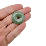 A 30mm green aventurine crystal donut pendant with a polished, smooth surface, featuring natural stone patterns and a central hole.