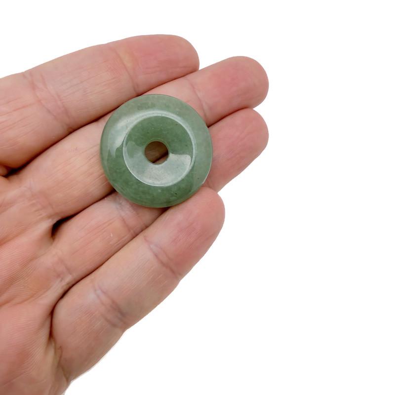 A 30mm green aventurine crystal donut pendant with a polished, smooth surface, featuring natural stone patterns and a central hole.