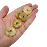 Yellow jade crystal donut pendant from GemstoneGO, 30mm Pi stone with smooth, polished surface and vibrant yellow color.