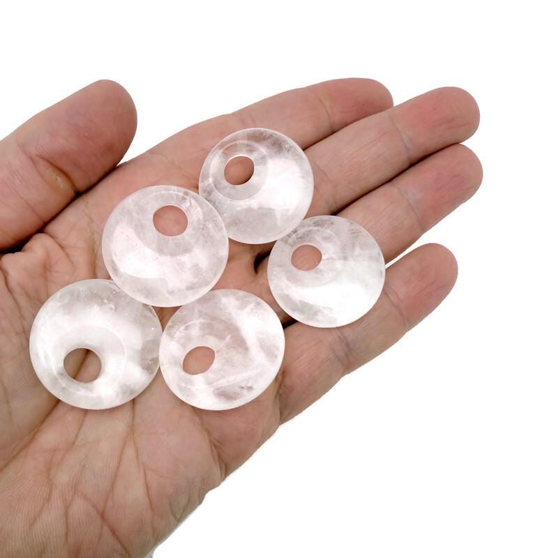 Clear quartz crystal donut pendant from GemstoneGO, 30mm Pi stone with polished, translucent appearance and smooth rounded edges.