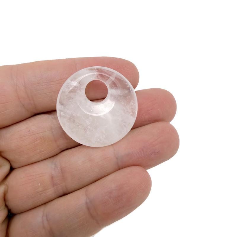 Clear Quartz Crystal Donut from GemstoneGO, 30mm Pi Stone with a polished, translucent appearance and smooth, rounded shape.