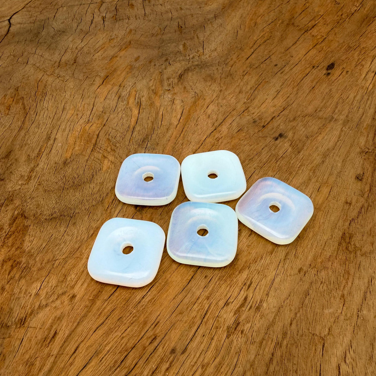 Opalite square crystal donut pendant, 30mm Pi stone from GemstoneGO, showcasing a smooth, polished gemstone with a luminous glow.