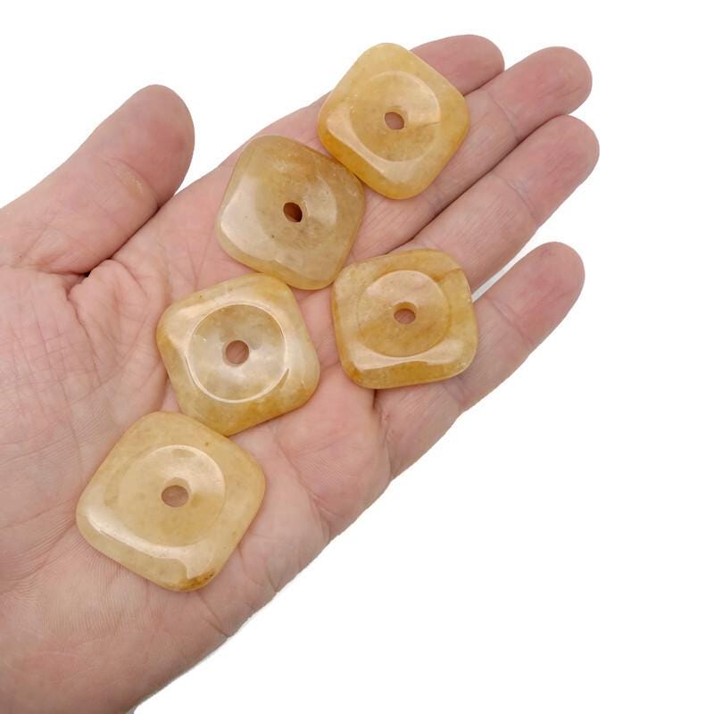 Yellow jade square crystal donut from GemstoneGO, 30mm Pi stone with vibrant yellow color and polished smooth surface.