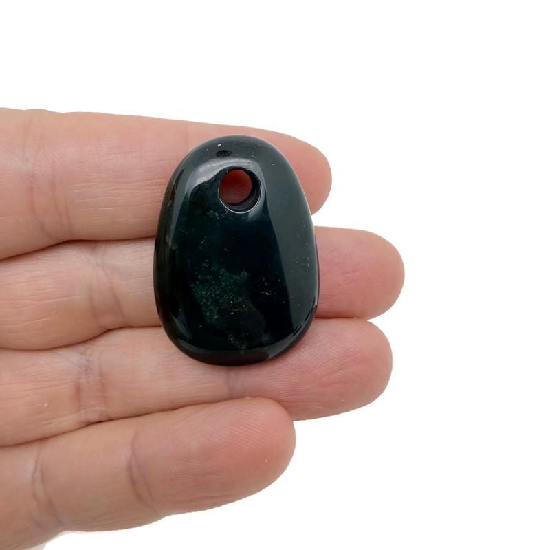 Oval crystal pendant from GemstoneGO featuring a natural stone bead for jewelry making, with a smooth, polished surface.