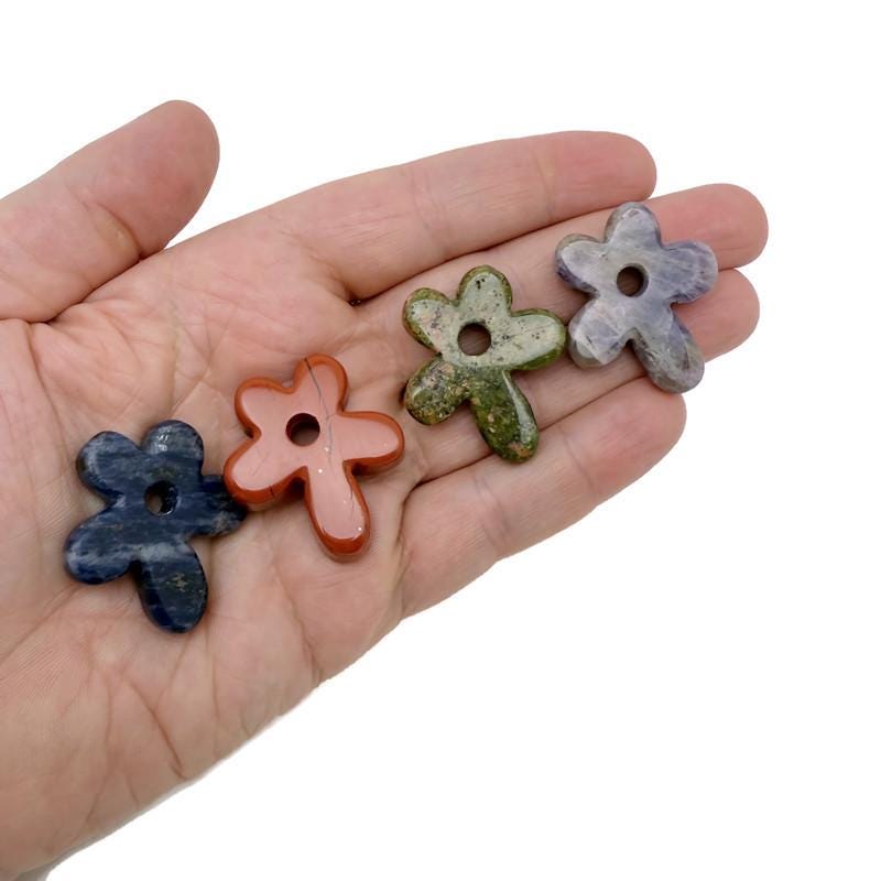 Carved crystal flower gemstone pendant with colorful gem accents from GemstoneGO, showcasing intricate floral design.