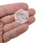 Faceted hexagon crystal pendant necklace bead from GemstoneGO, showcasing a shiny, multi-faceted gemstone in a close-up shot.