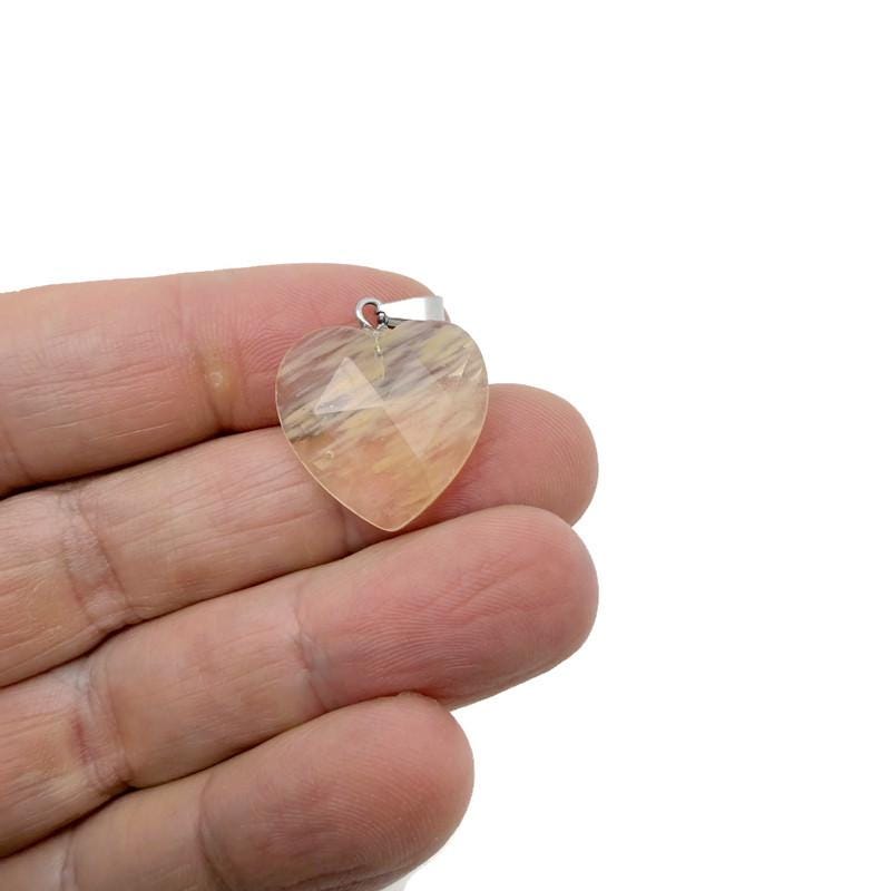Faceted heart-shaped natural crystal pendant from GemstoneGO, showcasing a sparkling crystal charm with intricate faceted details.