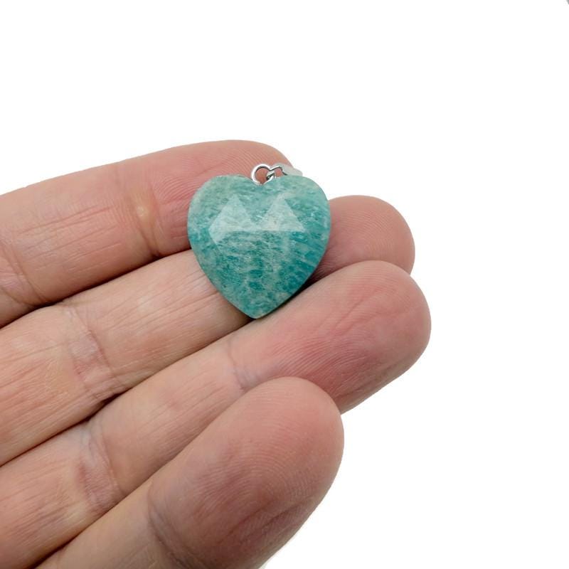 Faceted heart-shaped crystal pendant from GemstoneGO with natural crystal charm, showcasing a sparkling, clear gemstone on a delicate setting.