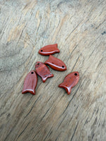 Red Jasper fish-shaped crystal pendant with healing properties, featuring a vibrant fish charm for jewelry.