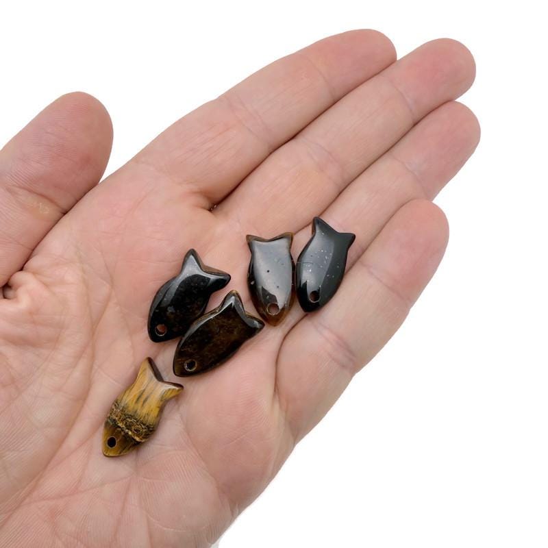 Tiger Eye fish-shaped crystal pendant with healing stone charm, showcasing a polished fish design for jewelry use.
