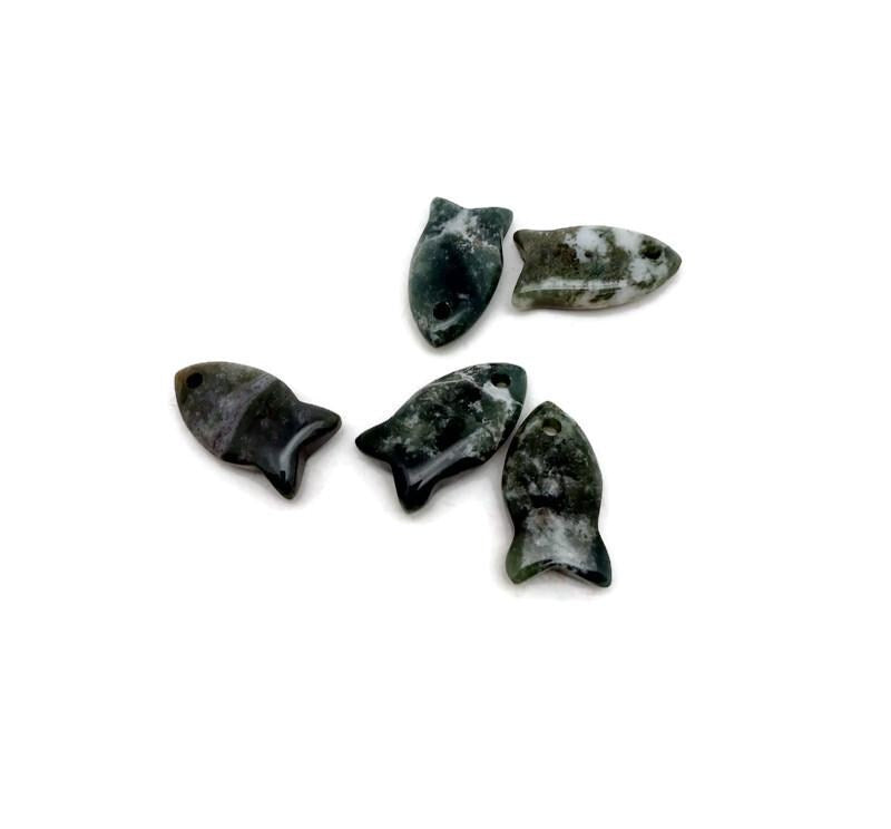 Moss agate fish-shaped crystal pendant with natural green and brown hues, ideal for jewelry and healing stones.