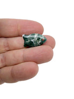 Moss agate fish-shaped crystal pendant with natural healing stone design, featuring a silver-toned bail for jewelry wear.