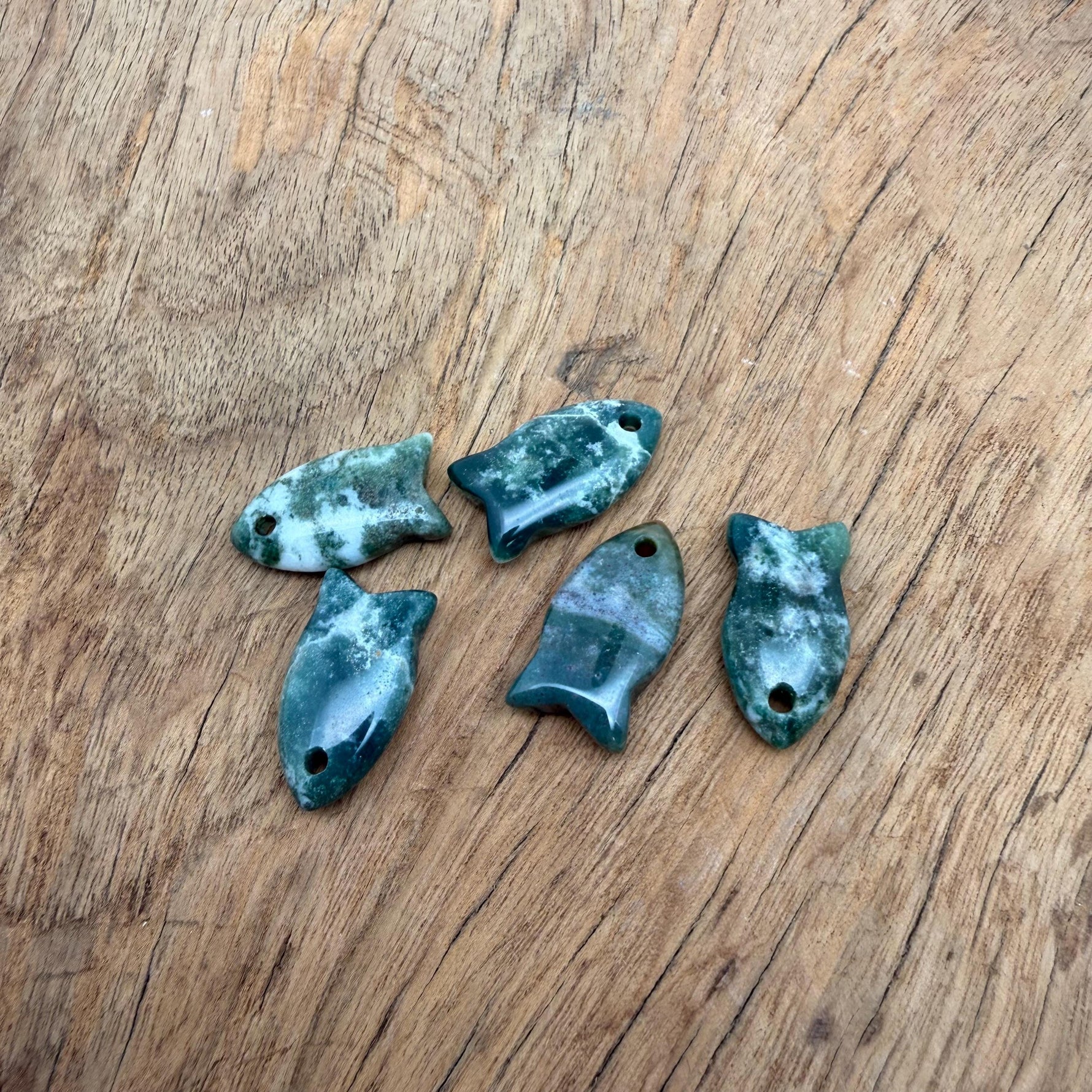Moss agate fish-shaped crystal pendant with healing stone design, crafted for jewelry, featuring a vibrant, natural stone appearance.